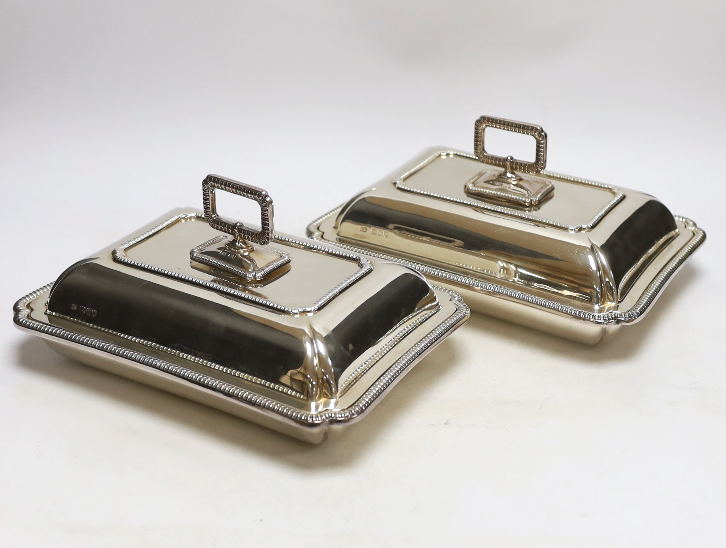 A pair of George V silver rectangular entrée dishes with covers and handles, by George Howson